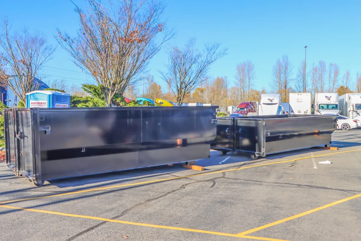 Professional dumpster rental service with roll-off container on residential driveway in Hagerstown